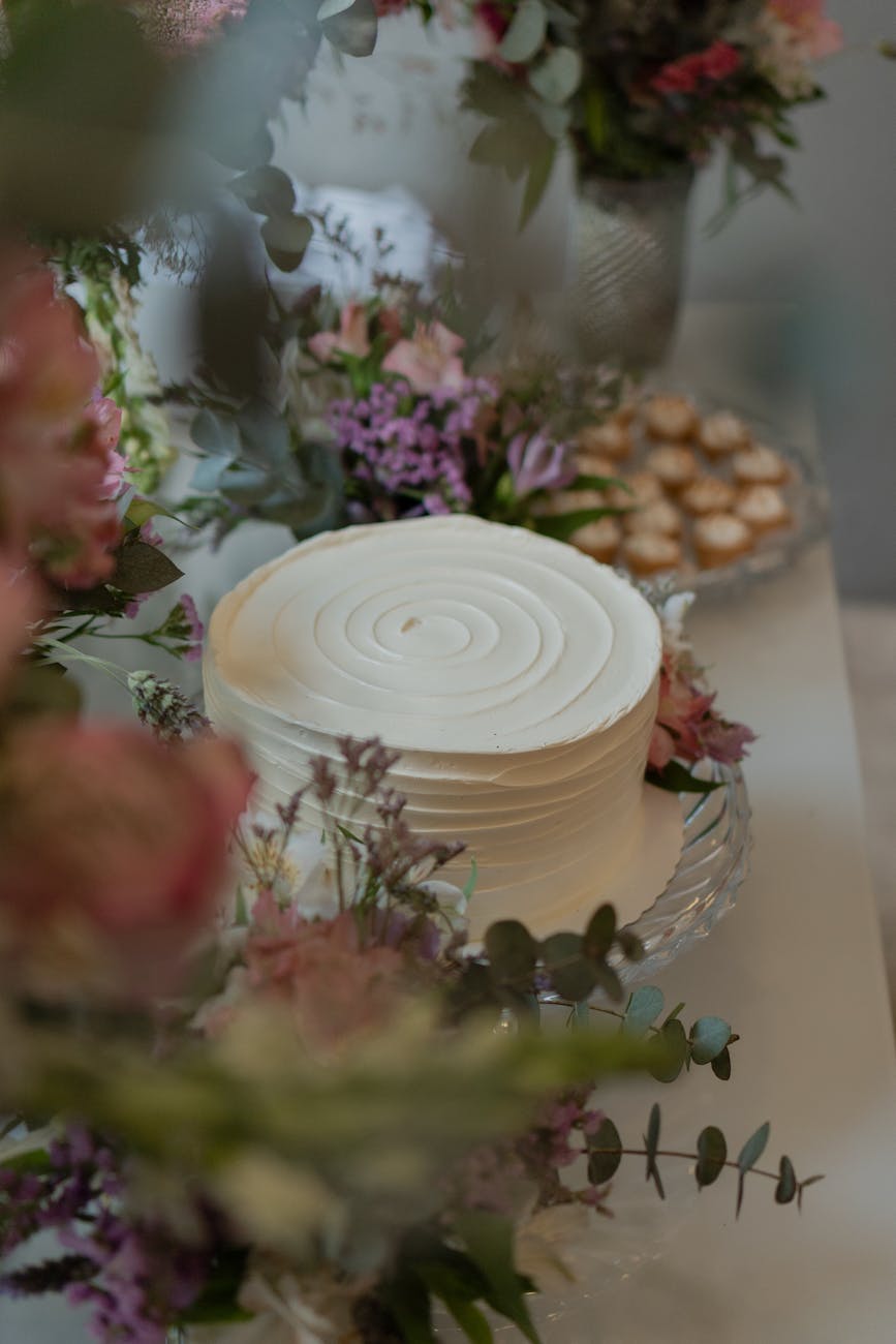 Delicate white wedding cake with floral accents, perfect for celebrations.