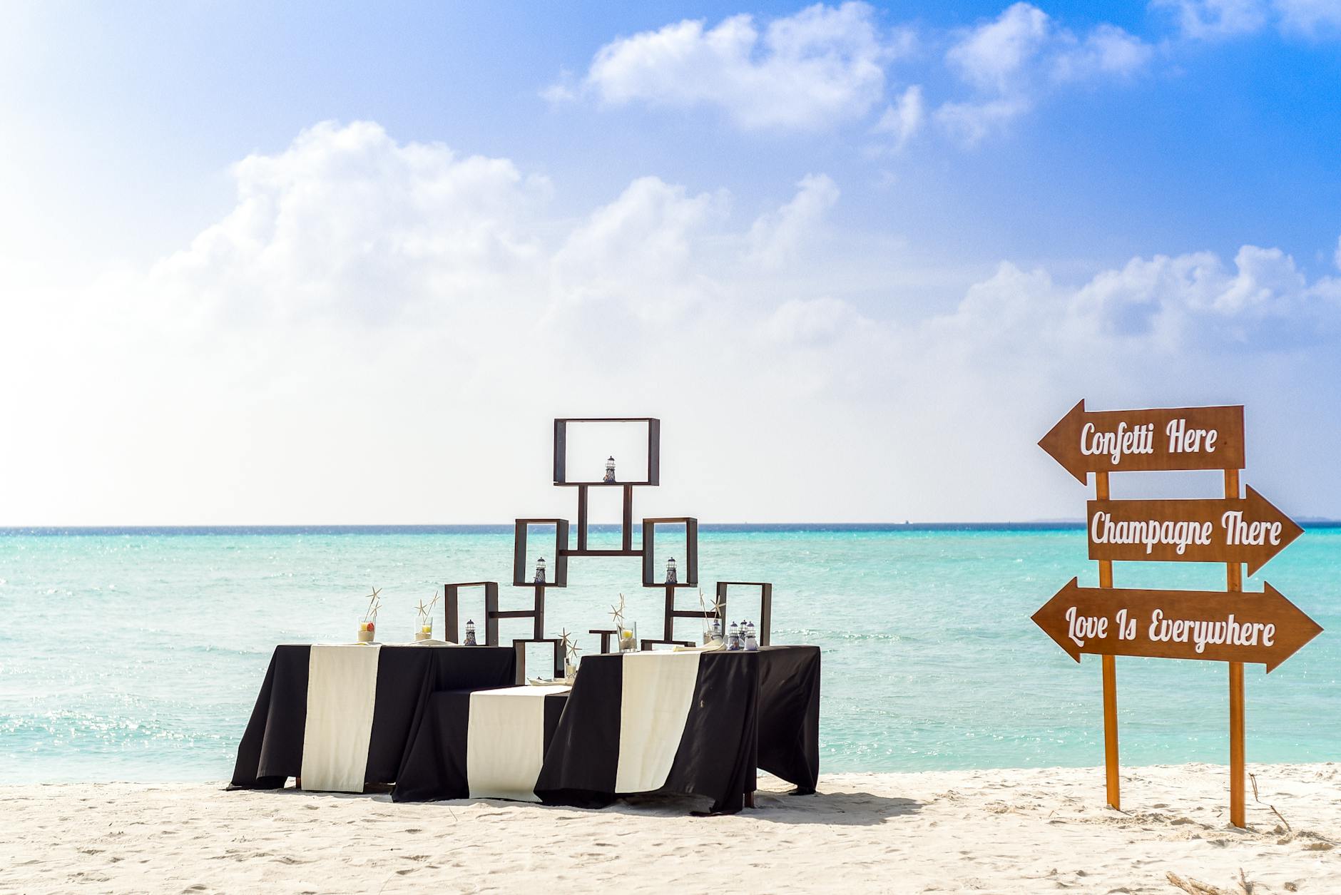 Stunning beach wedding setup with elegant decor and ocean backdrop.